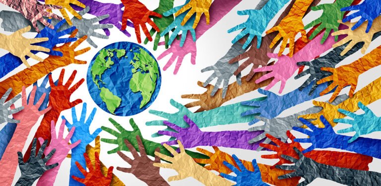 Colorful aper hand and arm cutouts reaching out for paper cut out of earth.